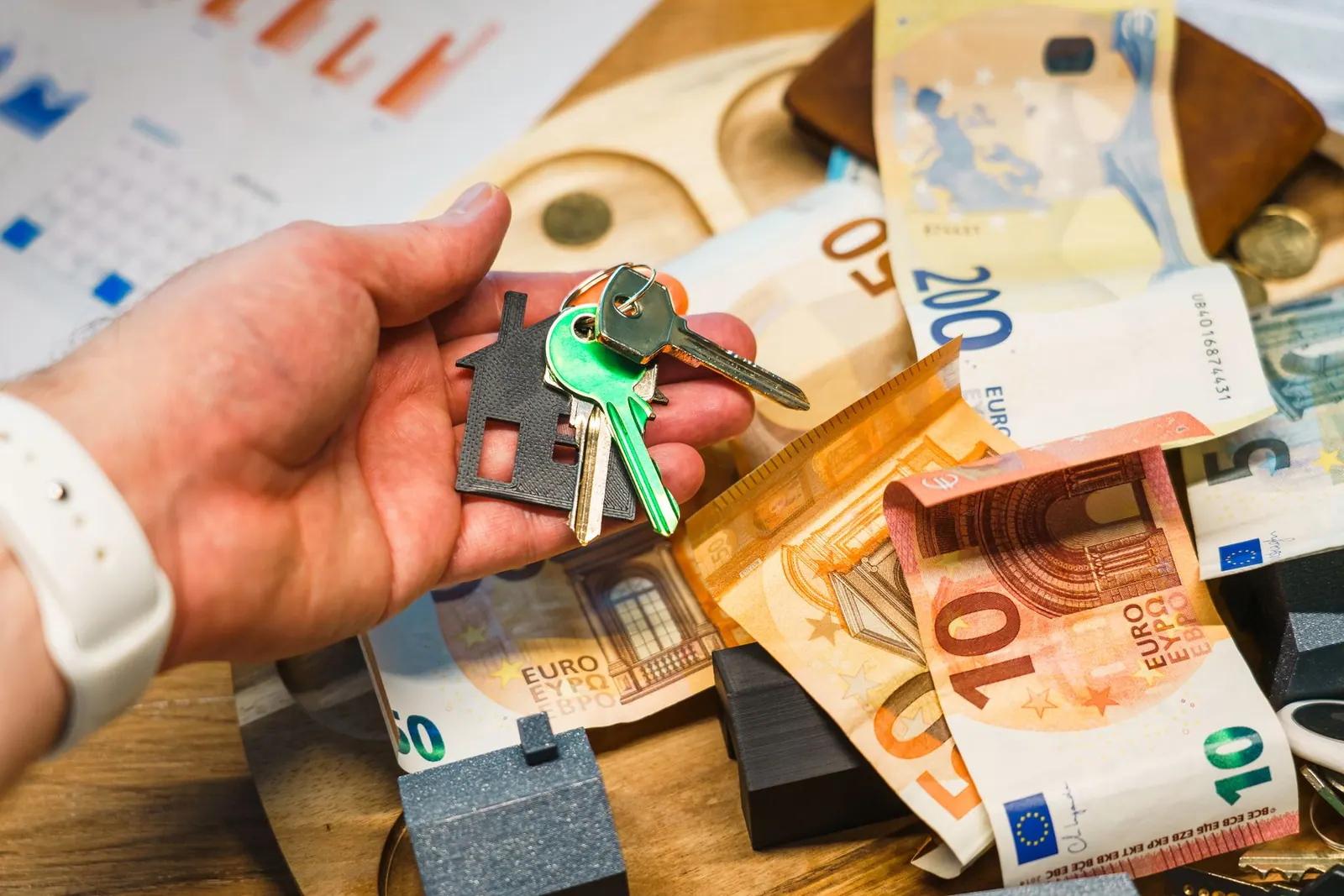 A hand holding house keys over euro banknotes, symbolizing real estate and finance. Real Estate Marketing Strategy Mistakes Seen From the Repair Side