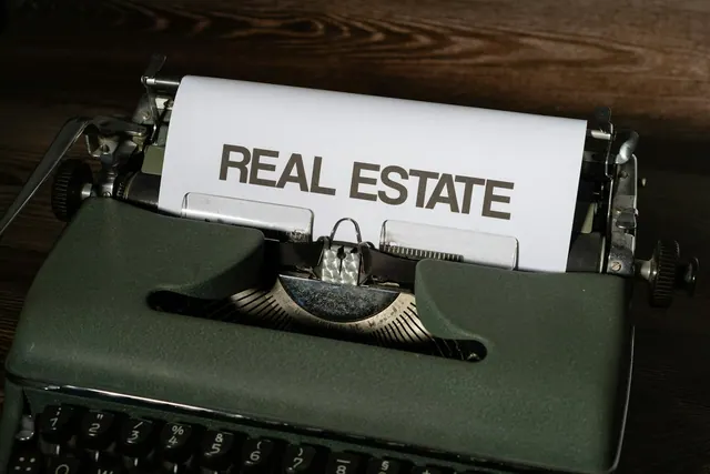 a close up of a typewriter with a real estate paper on it. Real Estate Social Media Guide for Teams
